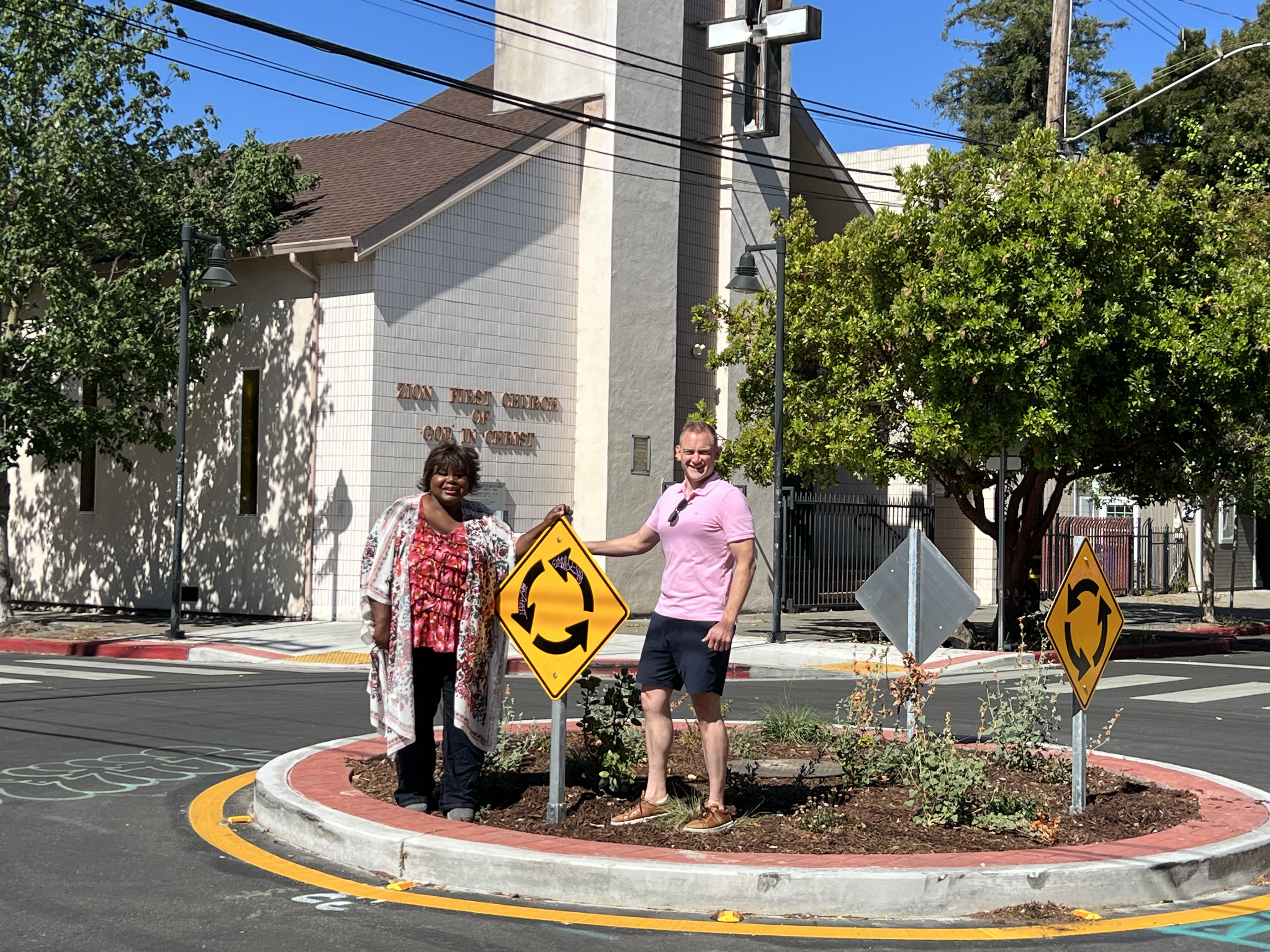 Standing with fellow Safe 8th Street volunteer Tamera White in the traffic cicrle on 8th and Chester, three years after the fiery crash at the same location.